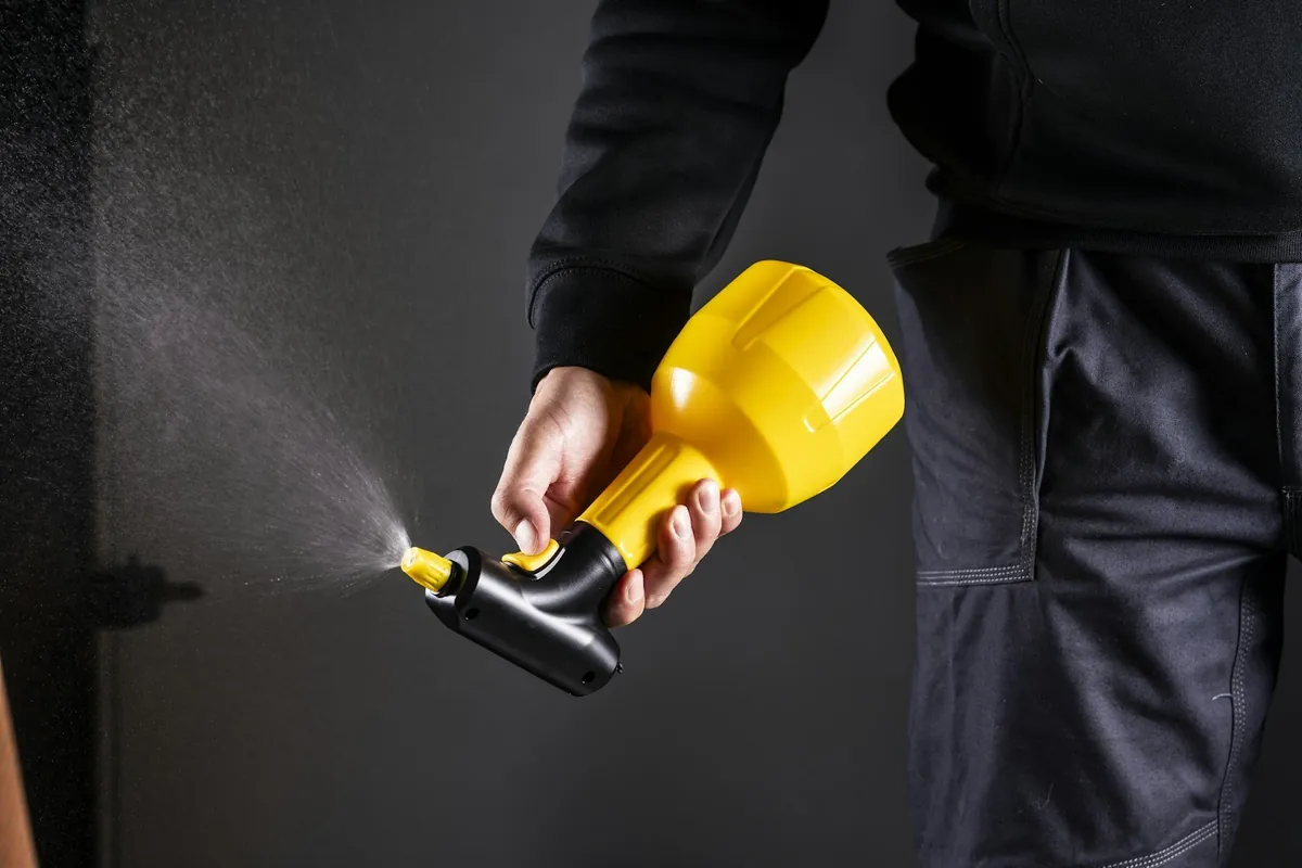 Pest control technician holding a sprayer — FDACS-licensed perimeter pest service in Polk County, FL
