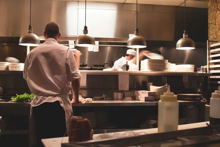 Commercial kitchen line — Atlantic Avenue's restaurant density makes documented roach programs part of doing business in Delray Beach FL