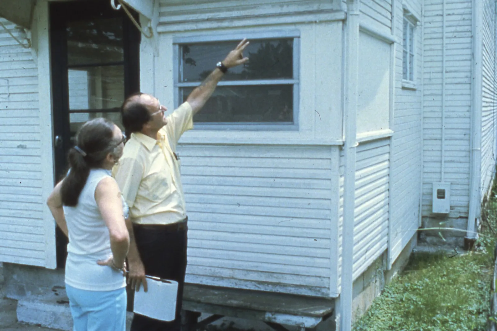 Licensed inspector reviewing exterior conditions on a home, the visible-evidence walkthrough an Orlando FL WDO termite inspection follows