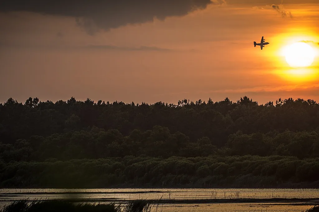 Mosquito control treatment pass — Boynton Beach FL's hundreds of drainage lakes keep the western communities' evening mosquito shift supplied